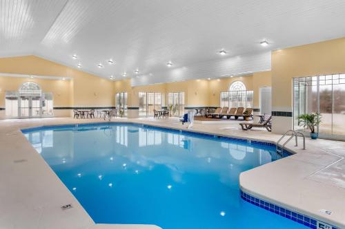 a large pool with blue water in a building at Country Inn & Suites by Radisson, Beckley, WV in Beckley