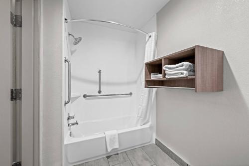 a bathroom with a shower and a bath tub with a shower at Clarion Pointe I-85 High Point - Archdale in Westwood