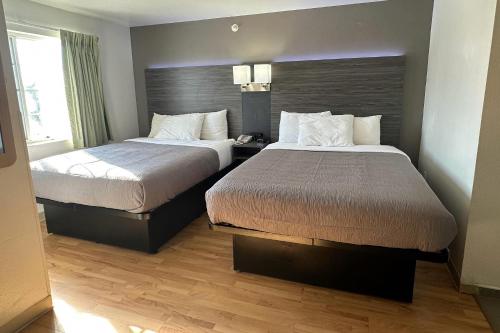 a hotel room with two beds and a window at Quality Inn Fishers - Indianapolis in Fishers
