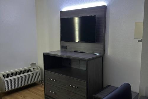 a black entertainment center with a flat screen tv at Quality Inn Fishers - Indianapolis in Fishers