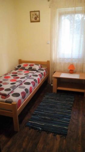 a bedroom with a bed and a table and a window at Country cottage in Konarevo