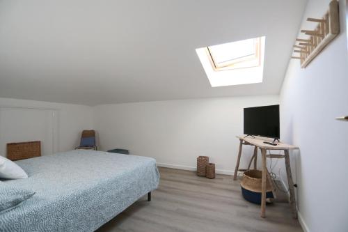 a bedroom with a bed and a television in it at mansarda fronte mare in Potenza Picena
