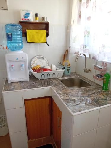 a kitchen with a sink and a counter top at Belaire BnB Ruaka 1 in Nairobi