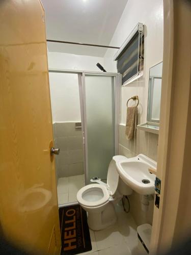 a bathroom with a toilet and a sink at Olango Island - S&E-1 Tiny Guest House Fully Furnished with Hot Shower, Washer, Wi-Fi, Netflix & King-size Bed in Lapu Lapu City