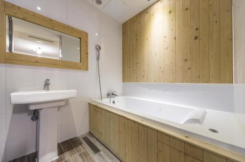 a bathroom with a sink and a bath tub at Daegu Play and Stay Hotel in Daegu