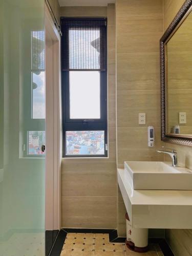 a bathroom with a sink and a window at Laimeront Dalat Hotel & Apartment in Da Lat
