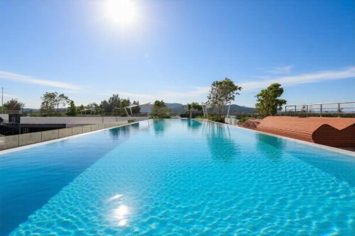 a large swimming pool with blue water at Laguna SkyPark new brand apartments in Phuket