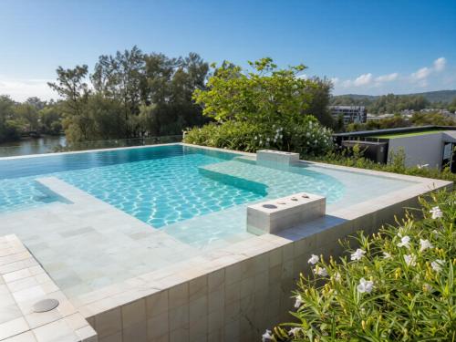 a swimming pool on top of a house at Laguna SkyPark new brand apartments in Phuket