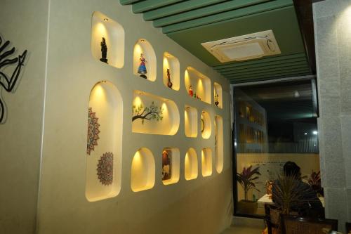 a wall with a bunch of pictures on it at APL Residency by Darling in Vishāram