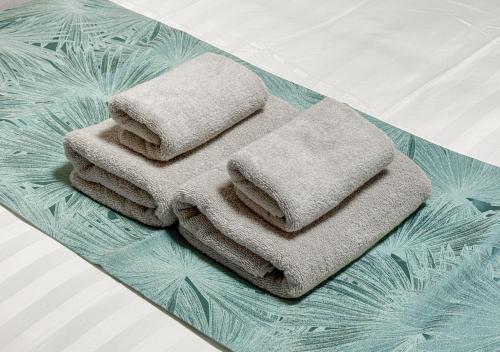 a pile of towels sitting on top of a table at C L Susukino in Sapporo
