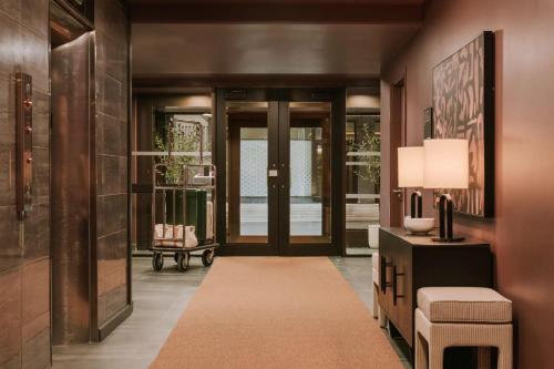 a hallway with aoyer with a door and a rug at The Arlo, BW Signature Collection in Ottawa