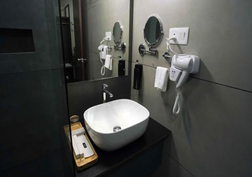 a bathroom with a white sink and a mirror at River Bay Athirappilly in Athirappilly