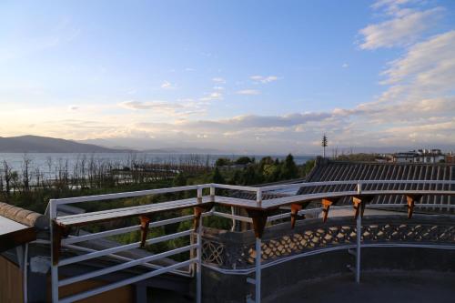 a balcony with a view of the water at Erhaike Seaview Inn in Dali