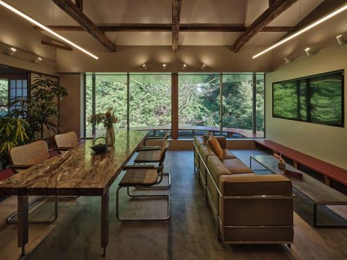 a living room with a large table and a couch at shinso hakone in Hakone