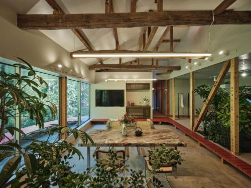 a living room with a table and some plants at shinso hakone in Hakone