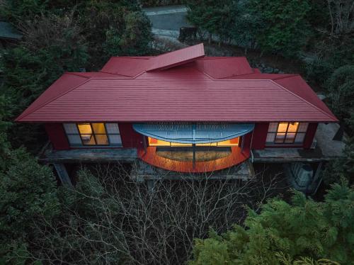 a house with a red roof on top of it at shinso hakone in Hakone