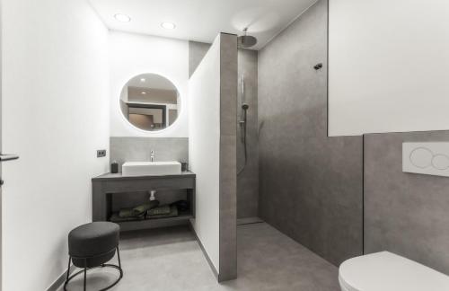 a bathroom with a sink and a mirror at ötztalLOFT in Längenfeld