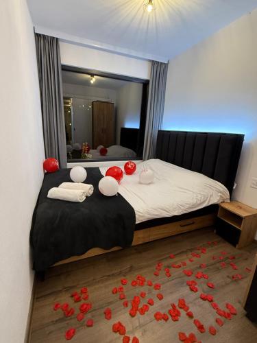 a bedroom with a bed with red roses on the floor at Tiny House by the forest “2” in Borod