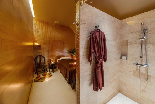a bathroom with a shower and a bedroom with a bed at LiT BANGKOK Hotel in Bangkok