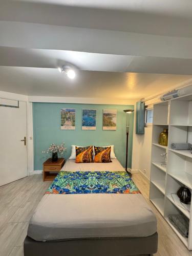 a bedroom with a large bed in a room at Maison d Eloise in Sartrouville