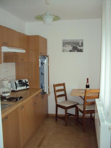 a kitchen with a table and a table and chairs at Apartments Ski Sonne Rehe in Rehefeld-Zaunhaus