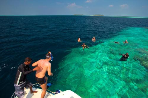 a group of people on a boat in the water at Kaani Grand Seaview in Maafushi