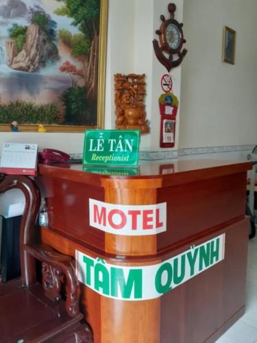a wooden counter with signs on it at Tâm Quỳnh Motel in Vung Tau