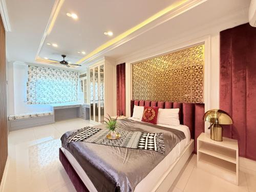 a bedroom with a large bed with a red headboard at Pool Villa Pattaya 5BD - Exquisite Pool Villa G in Nong Prue