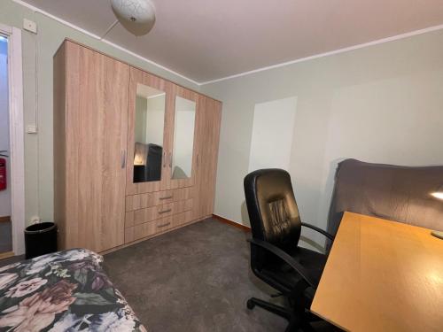 a room with a table and a chair and a mirror at Laplanders room 15 in Kiruna