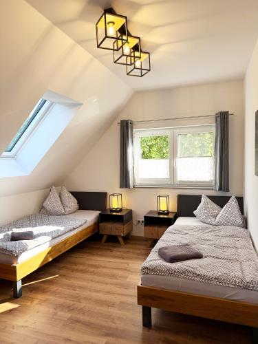 two beds in a room with two windows at Ferienwohnung-Karwe in Karwe