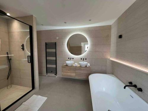 a bathroom with two sinks and a tub and a mirror at Ashley House Contemporary 4 Bedroom Stay for 13 in Inverness