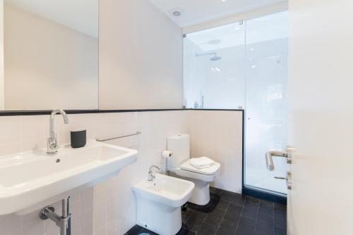 a white bathroom with a sink and a toilet at Oporto Trendy River in Porto