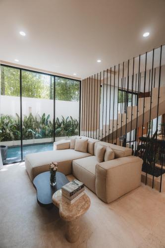 a living room with a couch and a table at Suom Apartments and Villas Canggu in Canggu