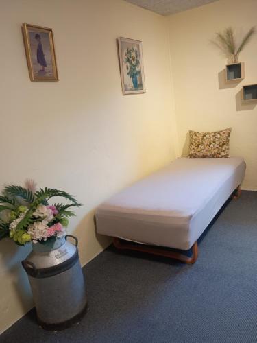 a hospital room with a bed and a potted plant at 70 m2 Anneks på gården in Malling