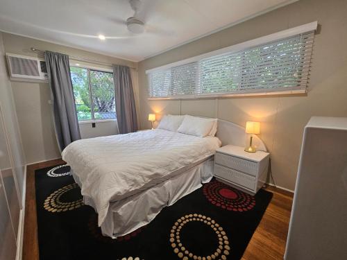 a small bedroom with a bed and a window at Bongaree Beach Shack - close to the bridge! in Bongaree