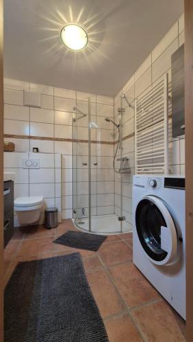 a bathroom with a washing machine and a shower at Ferienwohnung beim Schnellerbauer in Micheldorf in Oberösterreich