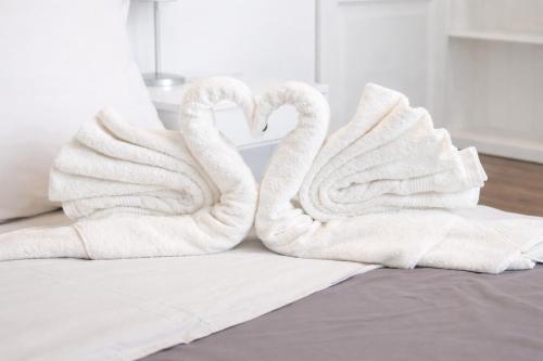 two towels shaped like swans sitting on a bed at Lo Exclusive Denia Els Poblets - Villa with private pool near to beach in Els Poblets