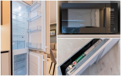 a kitchen with a microwave oven and a refrigerator at Sandal Apartments in Šiauliai