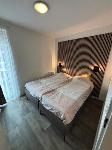 a bedroom with a bed with a wooden floor at Gerbrandion Appartement Verhuur in Vlissingen