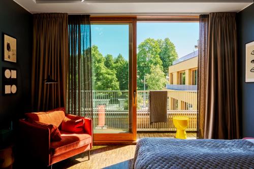 a bedroom with a bed and a large window at Backstage Hotel Stockholm in Stockholm