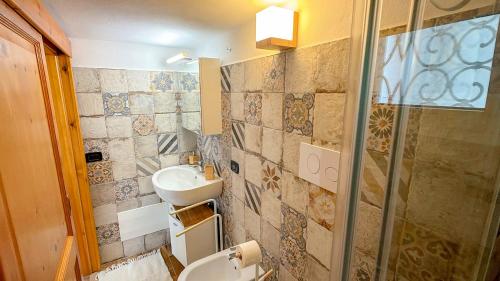 a bathroom with a sink and a shower at Casa CarMa - Relax & Comfort a Cala Gonone in Cala Gonone
