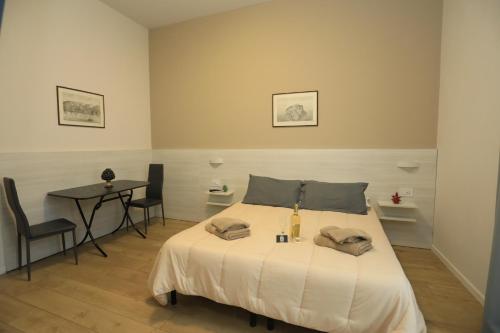 a bedroom with a bed with a table and chairs at B&B Costa degli Dei in Tropea