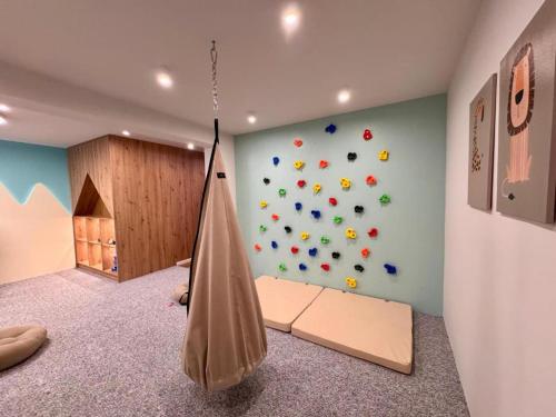 a room with a hammock and a rock wall at Apartament JOA in Zakopane
