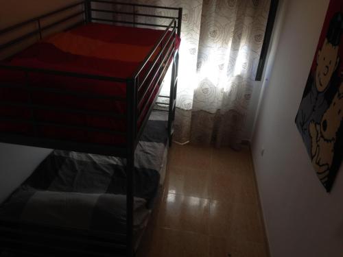 a room with a bunk bed and a stair case at Mi Apartamento en el Delta del Ebro in Deltebre