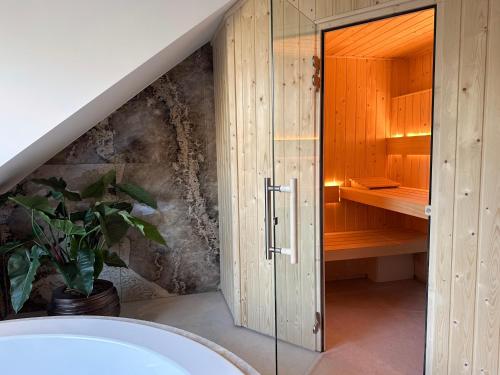 a bathroom with a shower and a bath tub at Van der Valk Hotel Harderwijk op de Veluwe in Harderwijk