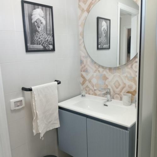 a bathroom with a sink and a mirror at Bilocale sul Trasimeno in San Feliciano