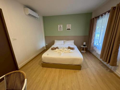 a bedroom with a bed with flowers on it at Tree Space Lanta Pool Stay Quiet & Near Beach in Ko Lanta