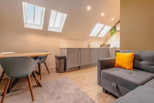 a living room with a couch and a table at High Street Hideaway, private entrance, parking in Bristol