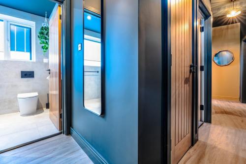 a pivot door in a house with a blue wall at High Street Hideaway, private entrance, parking in Bristol