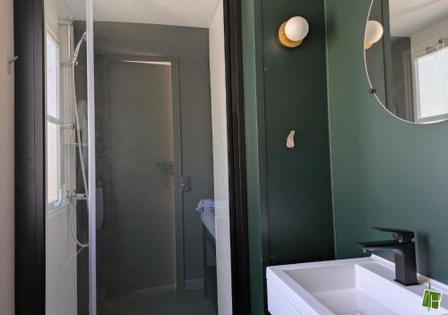 a bathroom with a sink and a mirror at Camping Houtum in Kasterlee